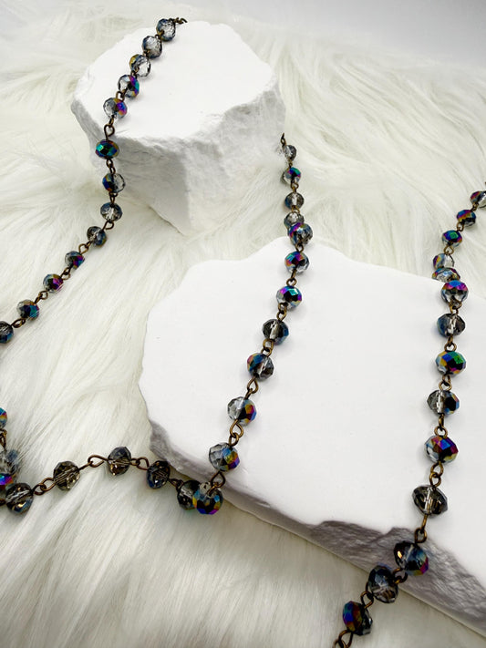 Necklace with multicolored beads on a white stone surface
