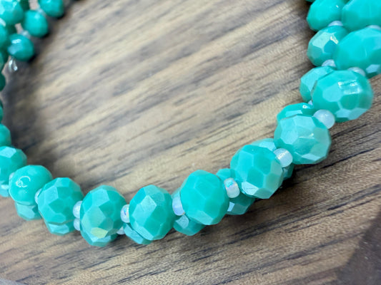Turquoise beaded necklace on a wooden surface