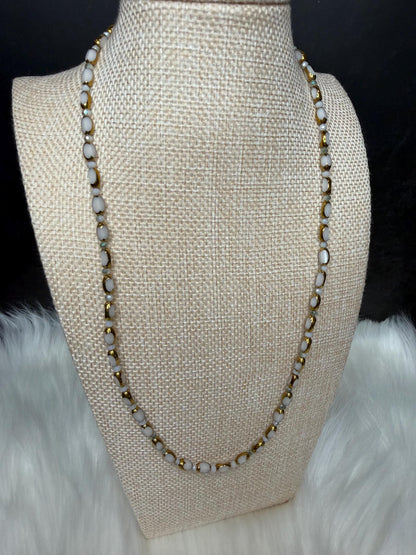 Necklace on a mannequin bust with a neutral background
