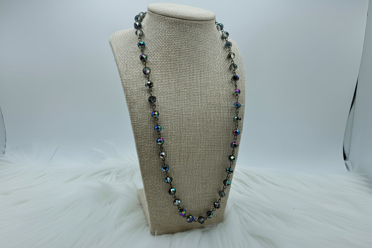 Necklace with multicolored beads on a beige bust