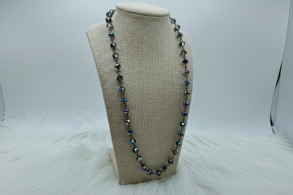 Necklace with multicolored beads on a beige bust