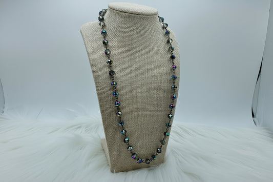 Necklace with multicolored beads on a beige bust