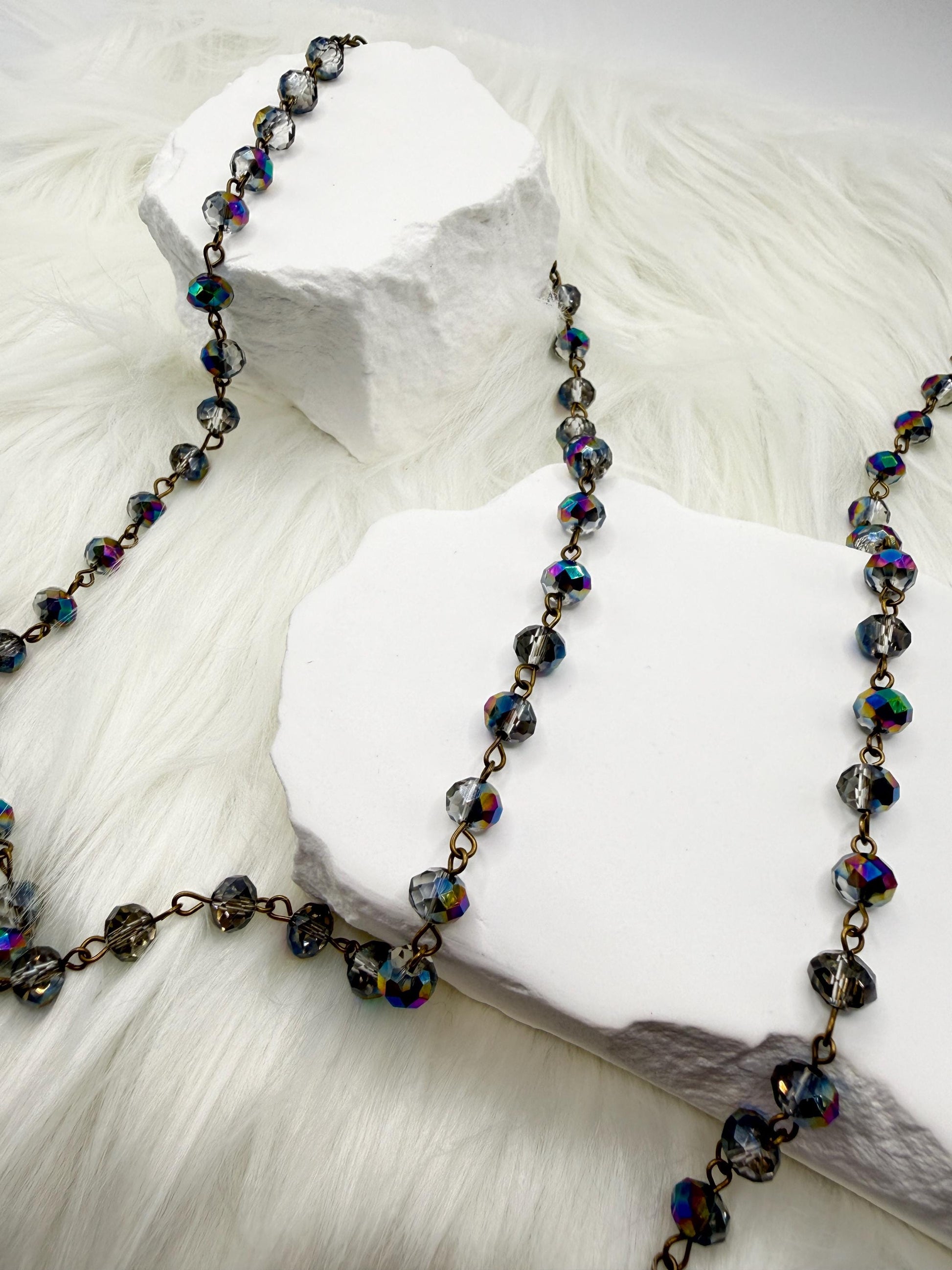 Necklace with multicolored beads on a white stone surface