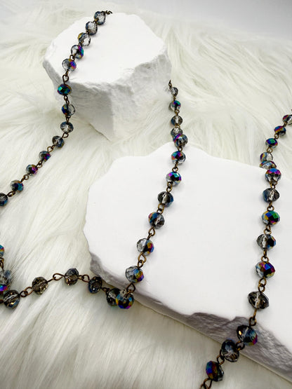 Necklace with multicolored beads on a white stone surface