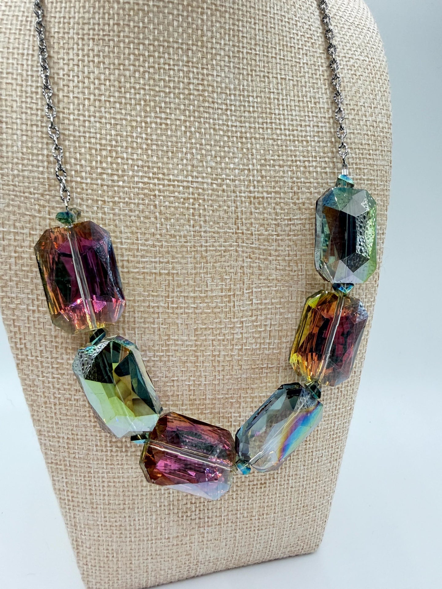 Necklace with multicolored crystal beads on a beige bust