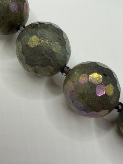 Faceted green beads on a white background