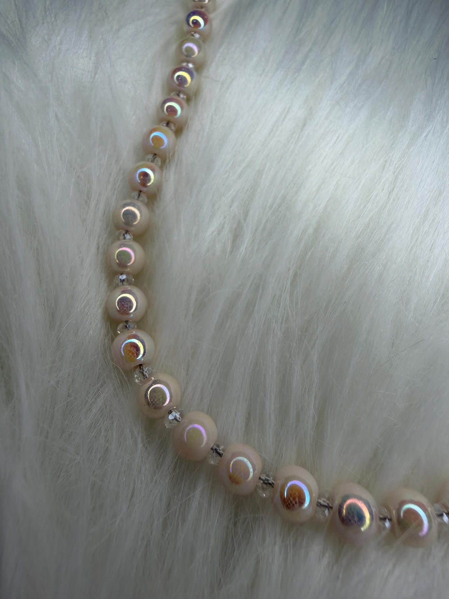 Necklace with round beads on a fur background