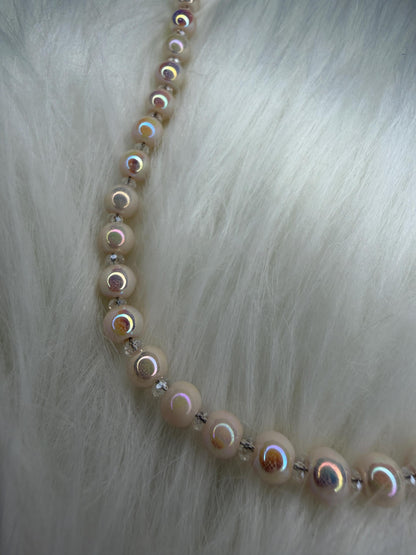 Necklace with round beads on a fur background