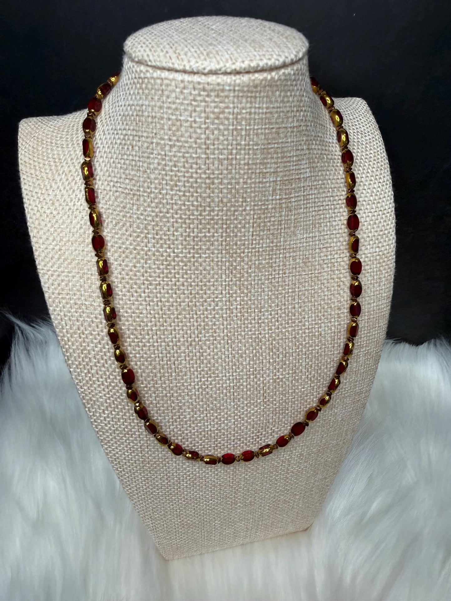 Beaded necklace on a mannequin bust with a dark background