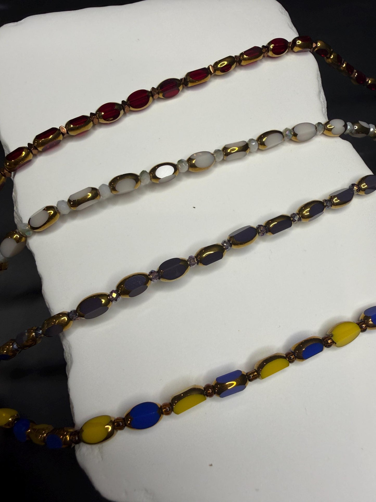 Colorful beaded necklace on a white surface