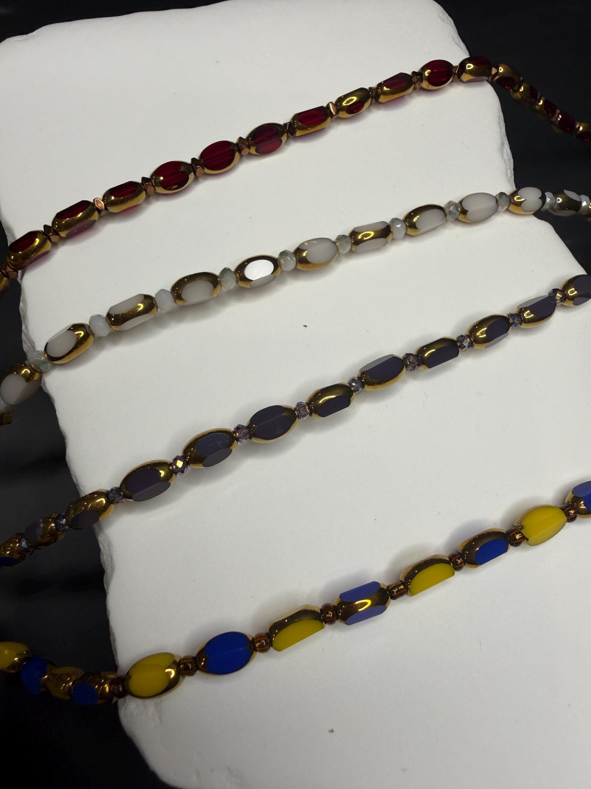 Colorful beaded necklace on a white surface