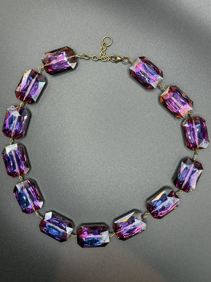 Necklace with purple crystal beads on a gray background
