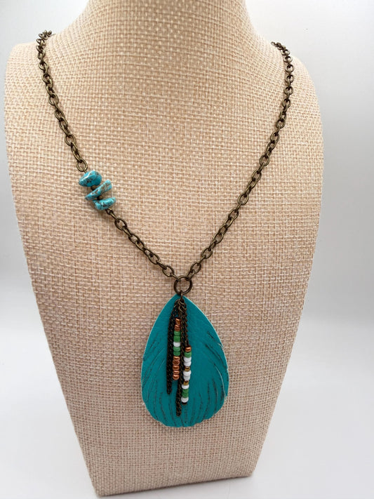 Necklace with a blue pendant on a beige bust