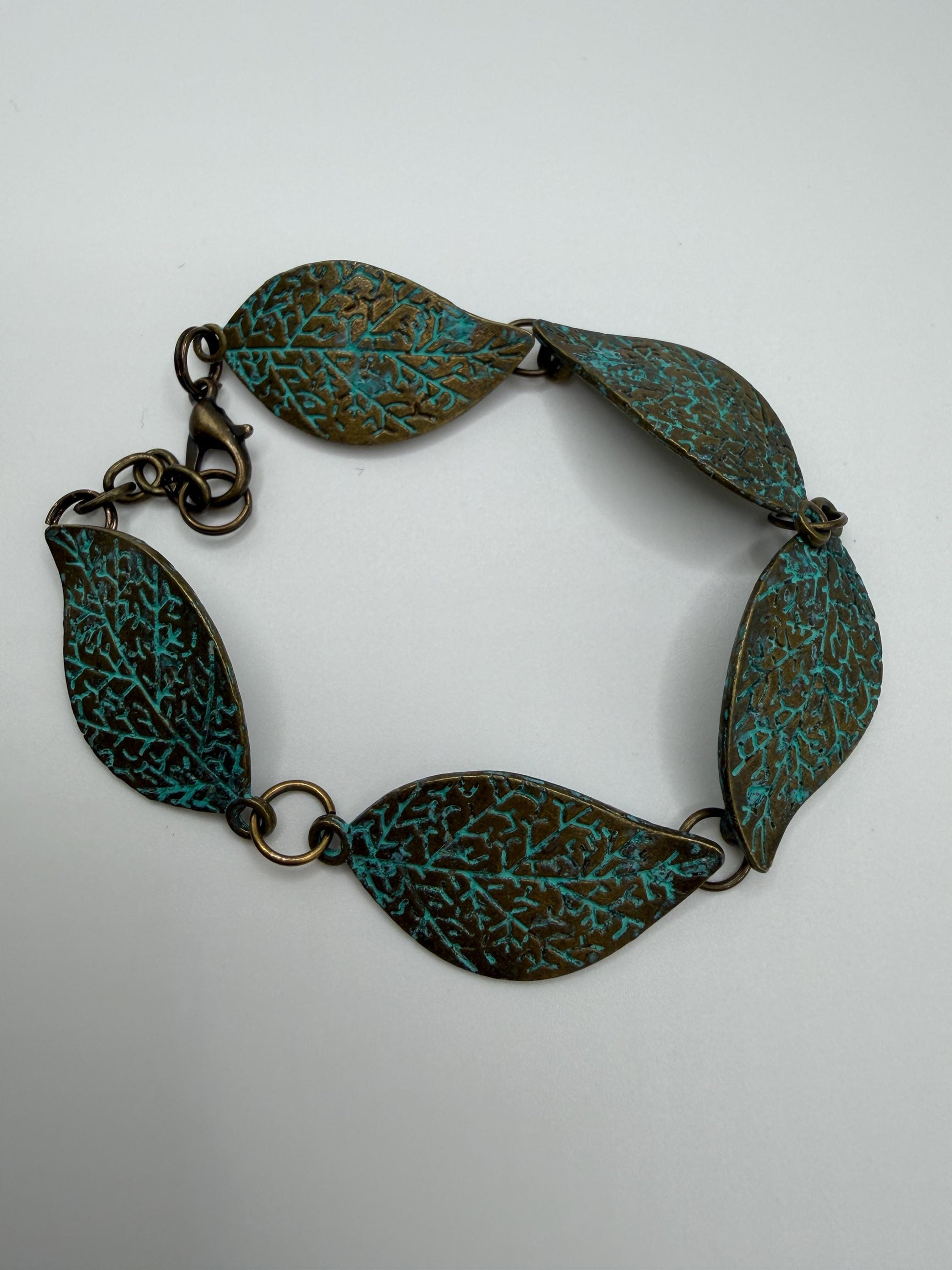 Bracelet with leaf-shaped links on a light gray background