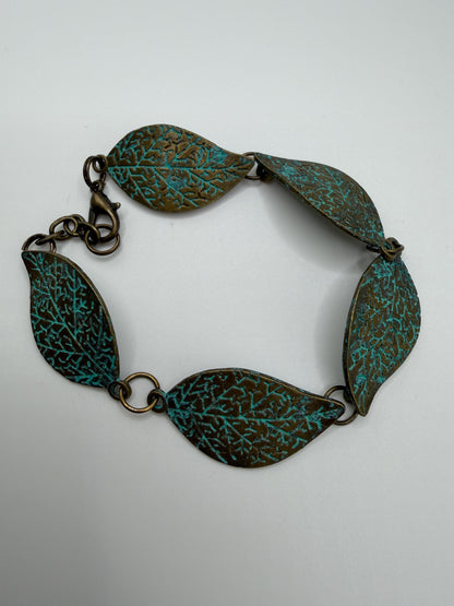 Bracelet with leaf-shaped links on a light gray background