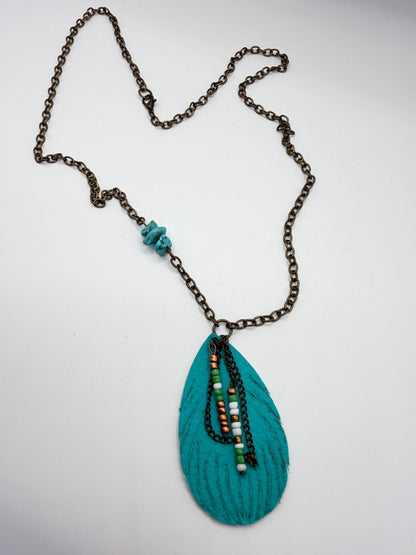 Necklace with a teal pendant and chain on a white background
