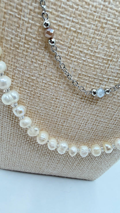 Pearl necklace on a textured beige surface