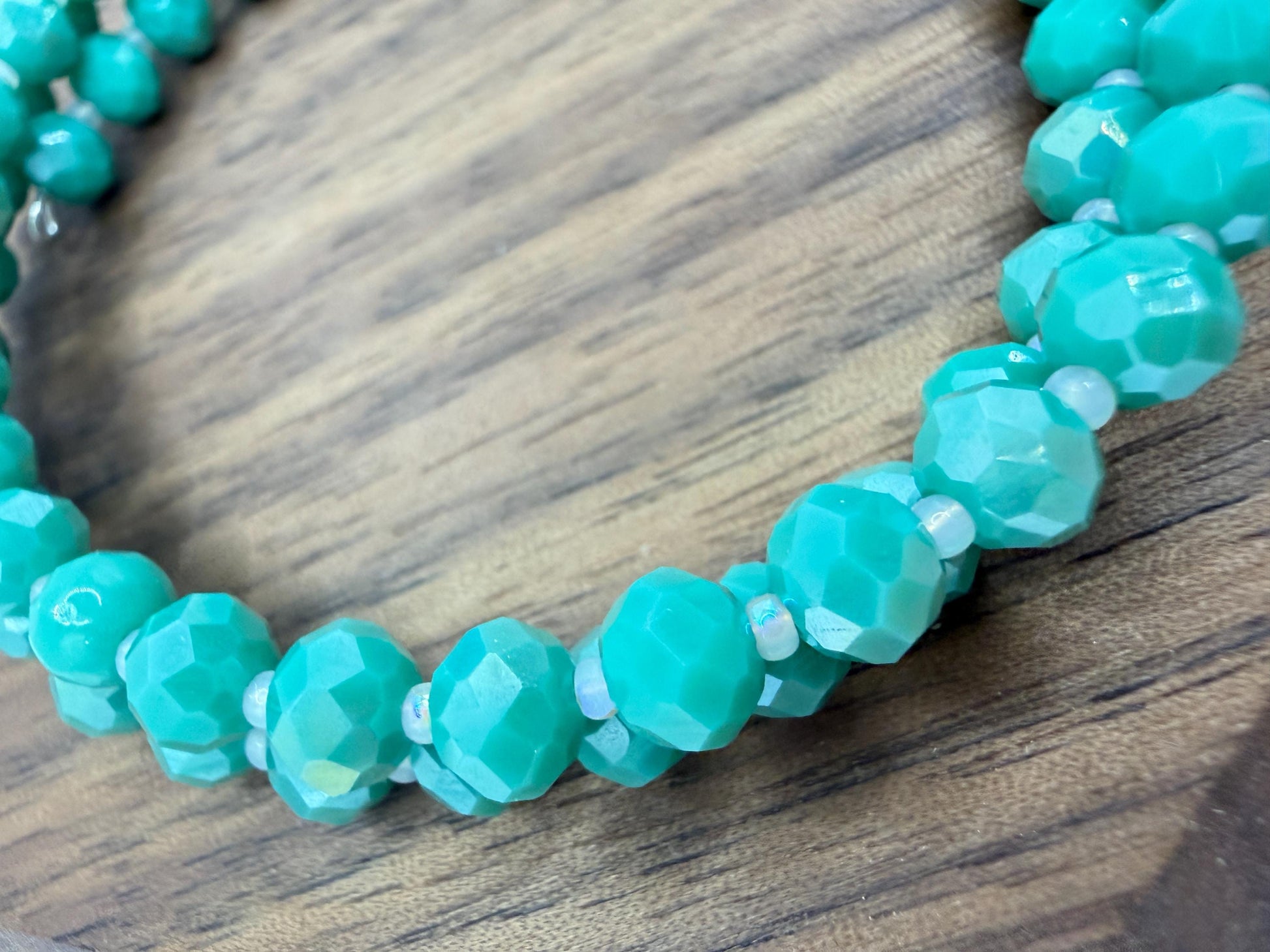 Turquoise beaded necklace on a wooden surface