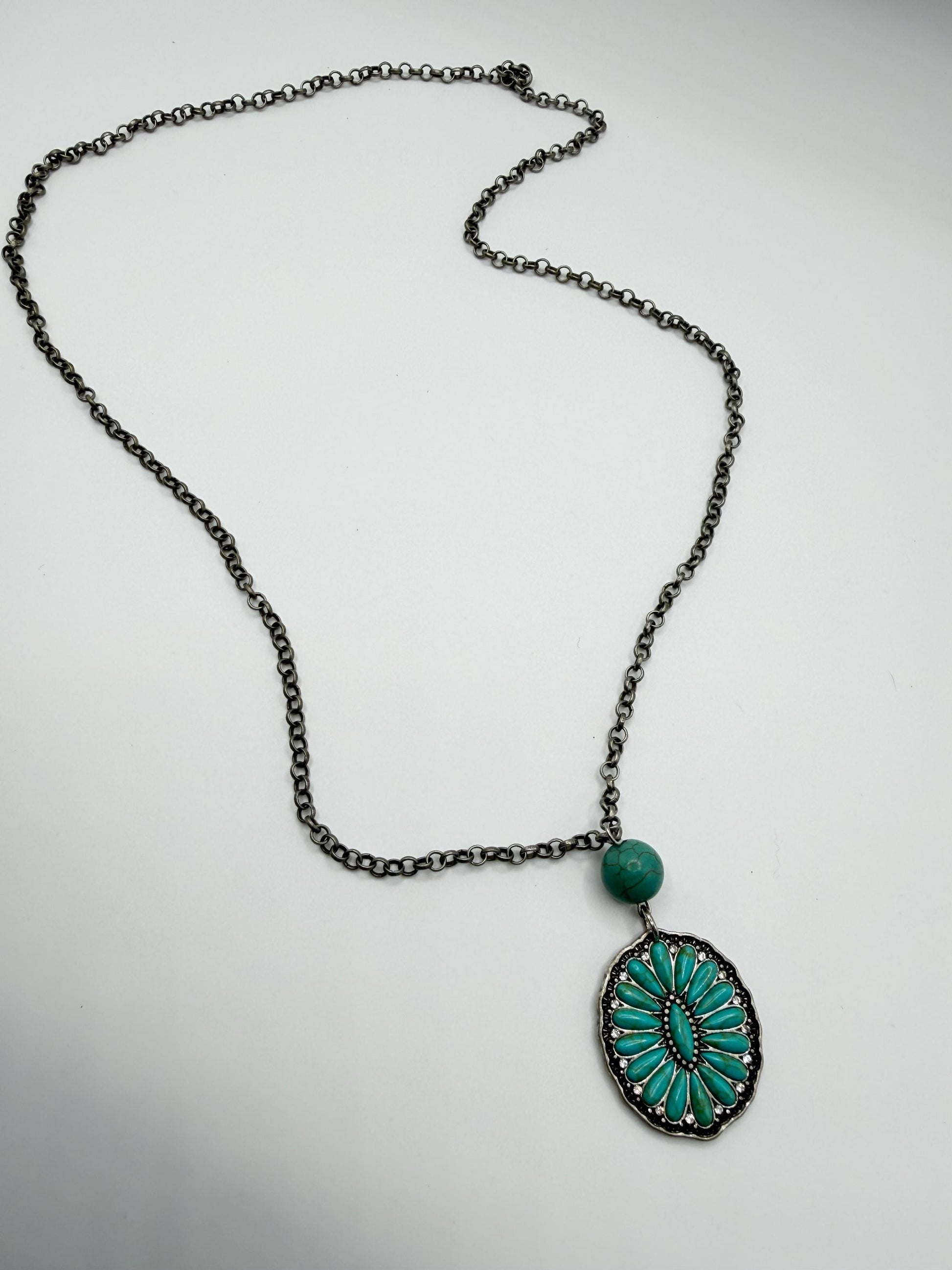 Necklace with a turquoise pendant on a light gray background