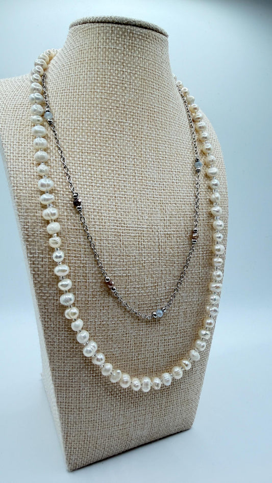 Pearl necklace on a beige bust against a light gray background