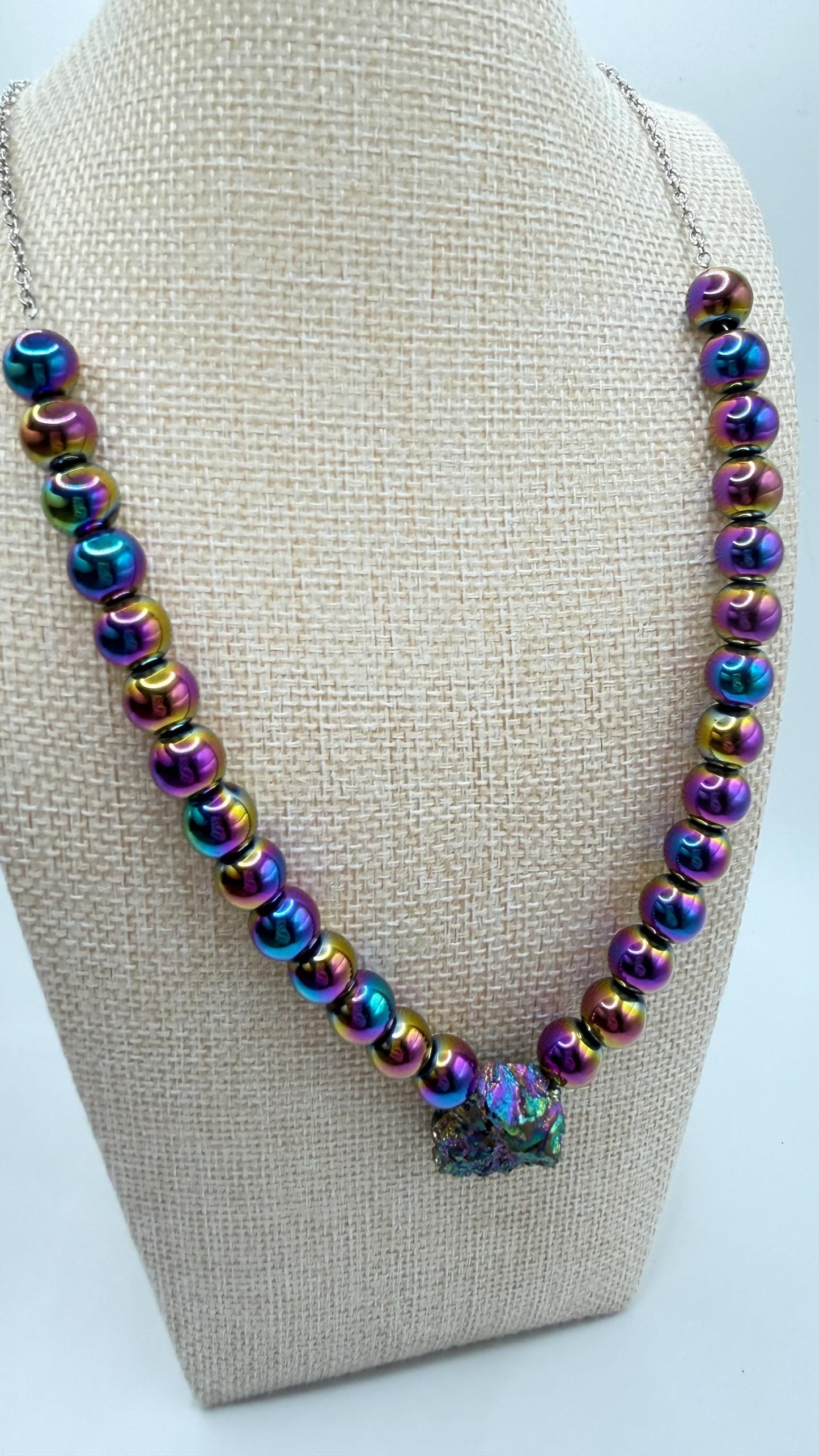 Necklace with multicolored beads on a beige bust