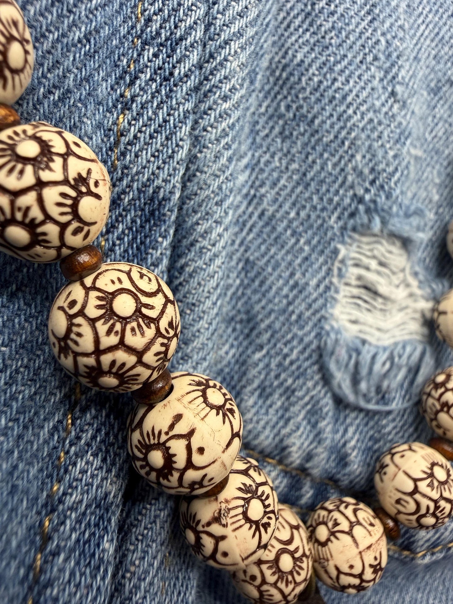 Bracelet with patterned beads on a denim background
