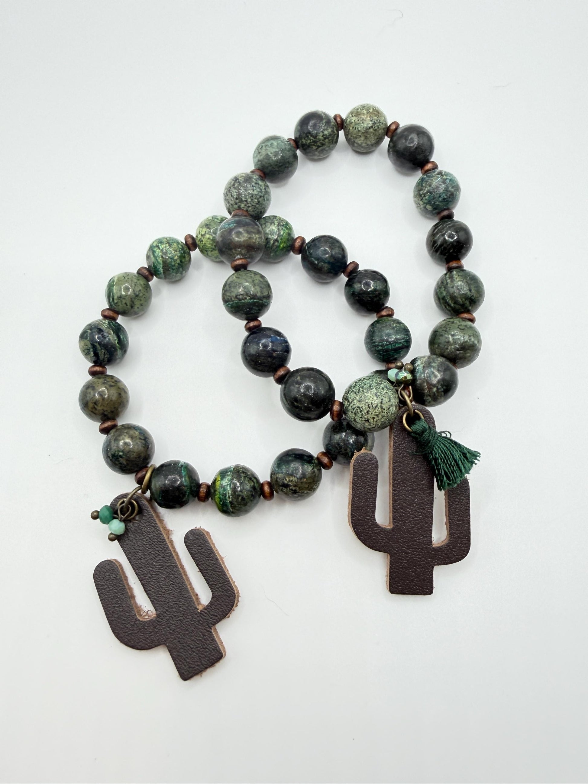 Beaded bracelet with cactus-shaped pendants on a white background