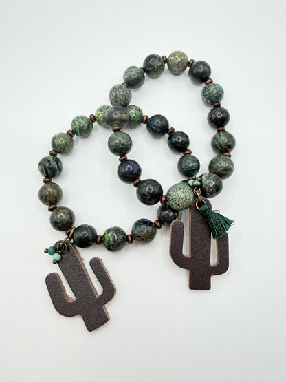 Beaded bracelet with cactus-shaped pendants on a white background