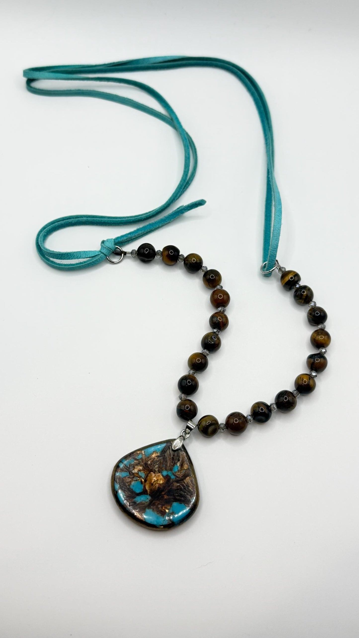 Necklace with beads and a pendant on a white background