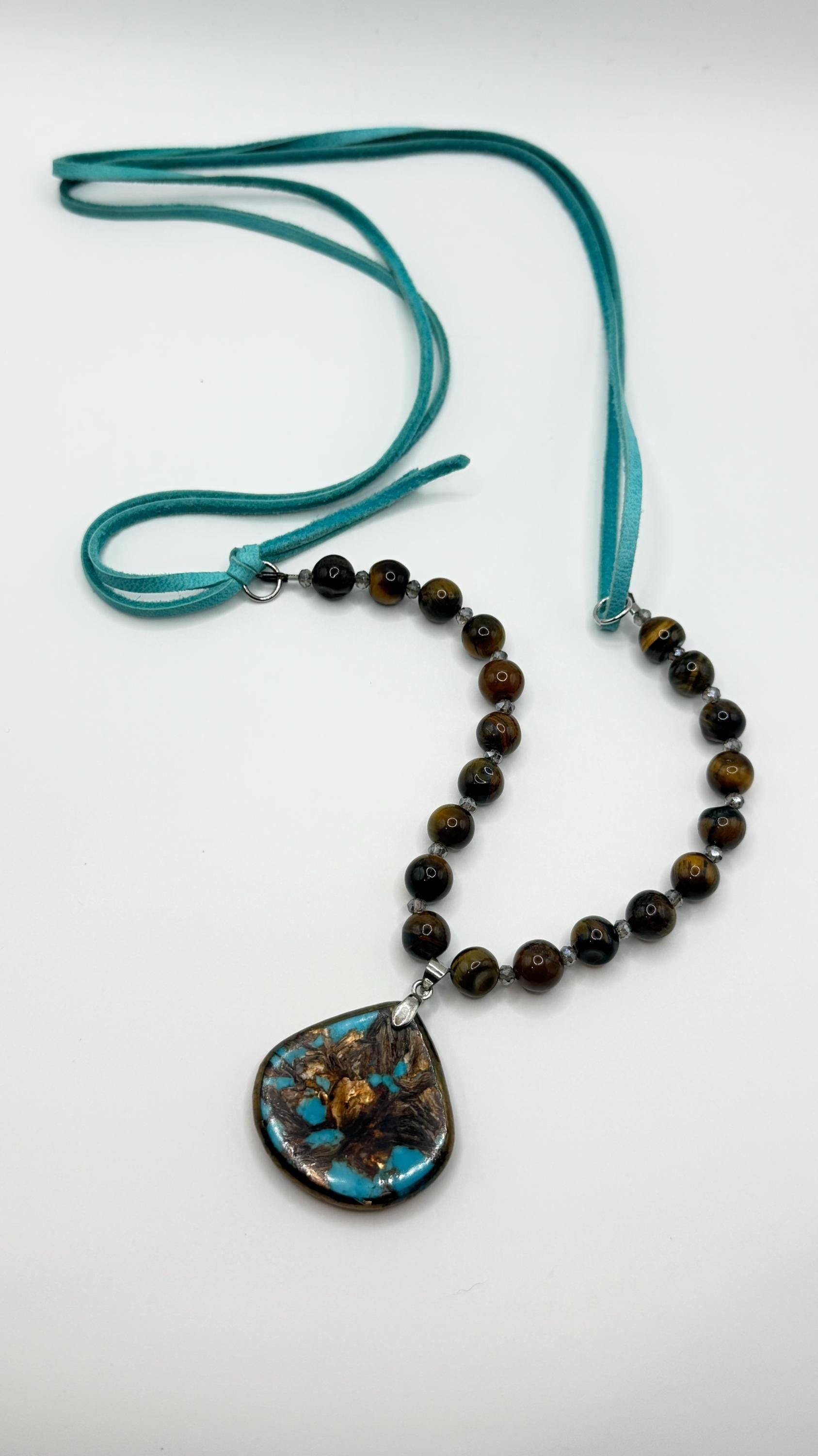Necklace with beads and a pendant on a white background