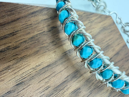 Turquoise beaded bracelet on a wooden surface