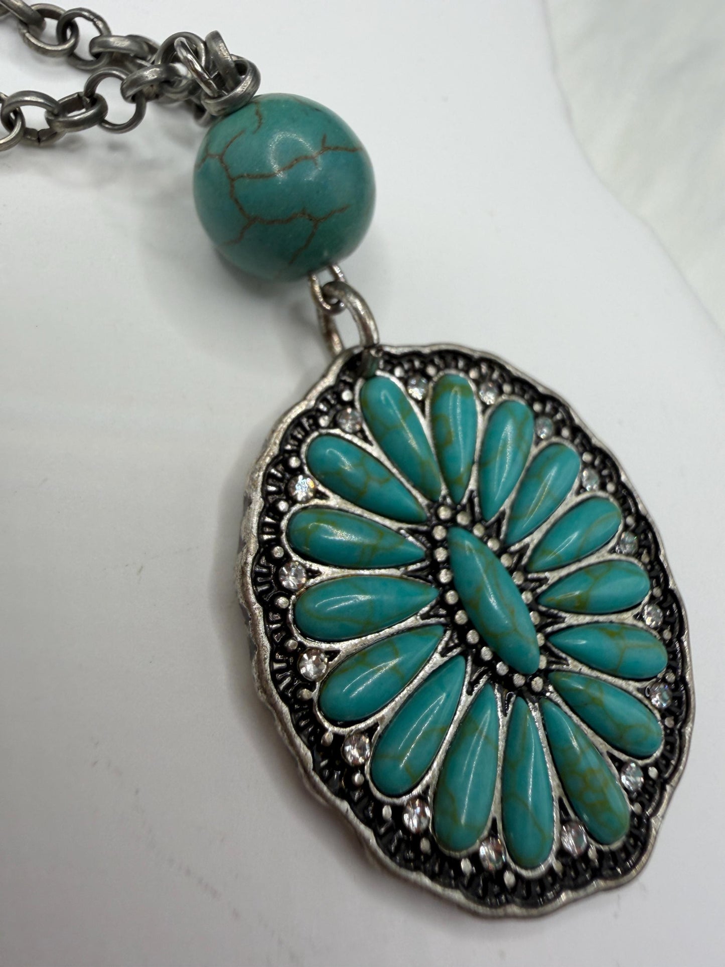 Turquoise pendant necklace on a white background