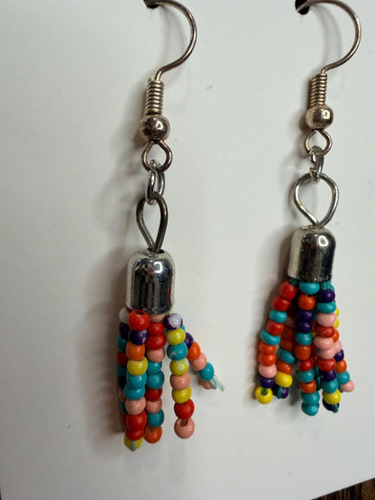 Colorful beaded earrings with silver hooks on a white background