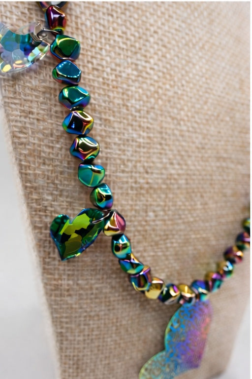 Multicolored beaded necklace on a textured beige surface