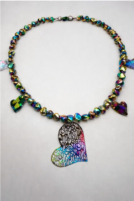 Necklace with colorful beads and a heart-shaped pendant on a light gray background