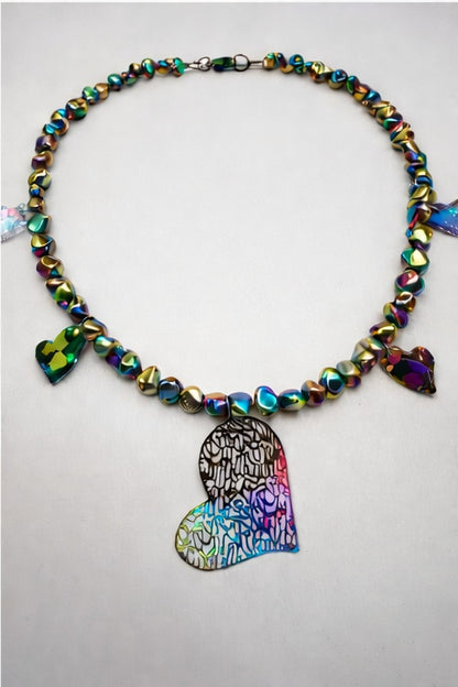 Necklace with colorful beads and a heart-shaped pendant on a light gray background